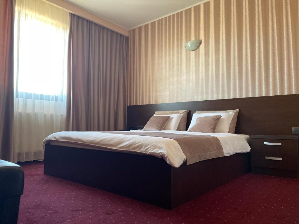 Postel nebo postele na pokoji v ubytování Hotel Athos