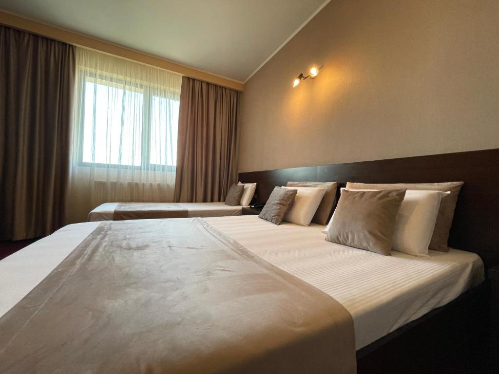 Postel nebo postele na pokoji v ubytování Hotel Athos
