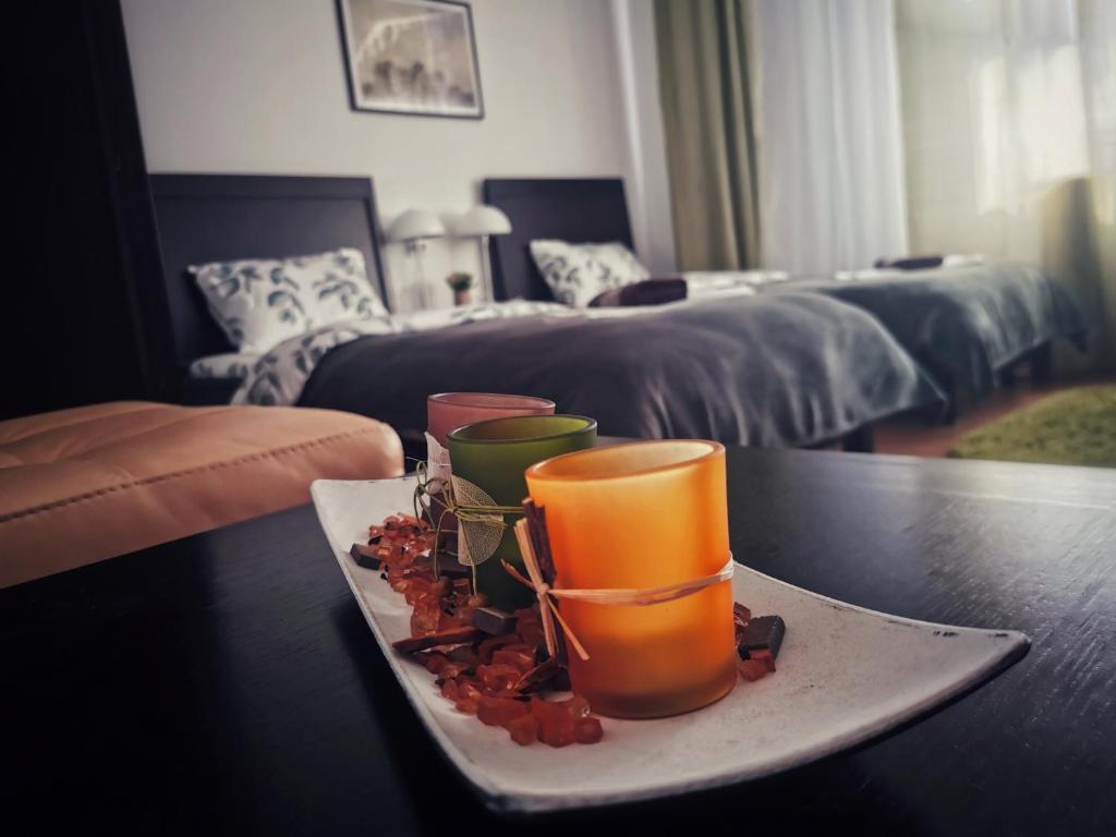 a plate with two cups on top of a table at Casa de oaspeti Wallendorf Bistrita Unirea in Bistriţa