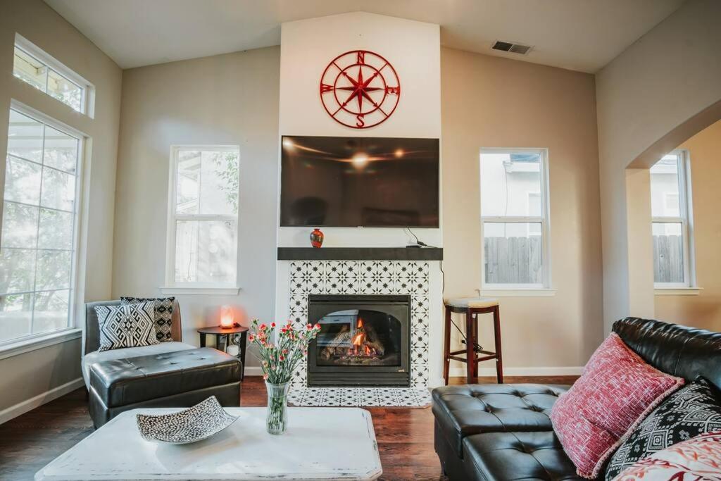 a living room with a couch and a fireplace at Central Coziness - Steps from Chico's Hub in Chico