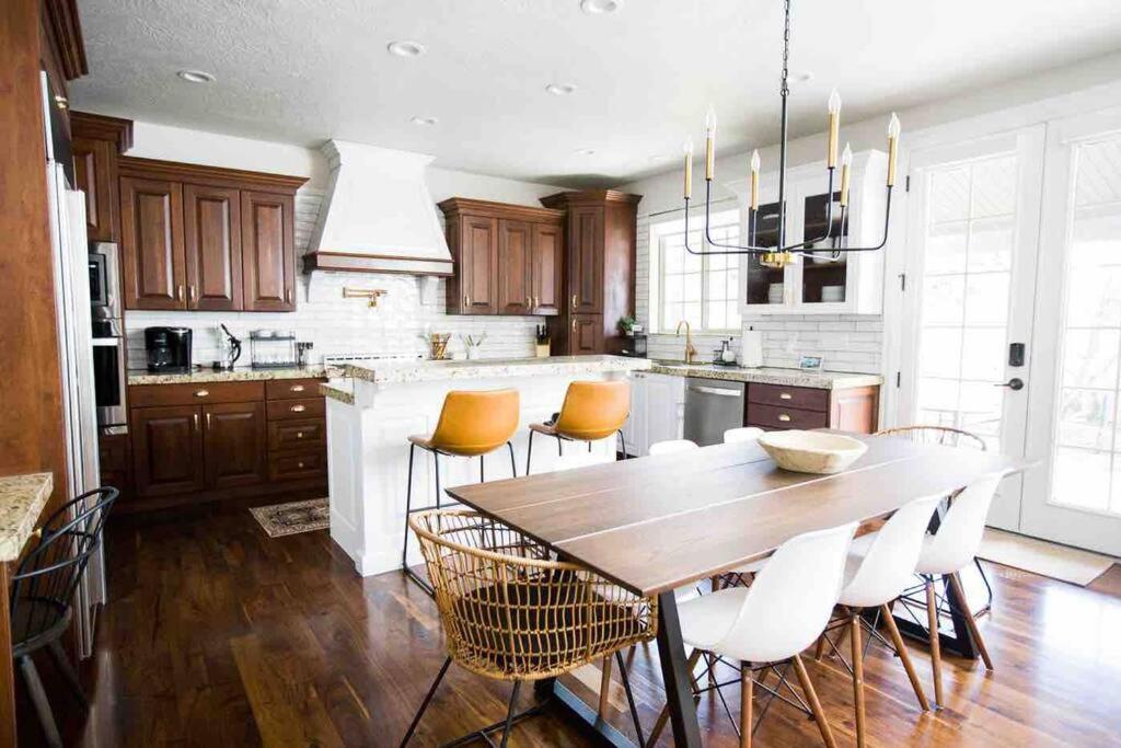 a large kitchen with a wooden table and chairs at *Spacious, Modern Mountain Vacation Home!* in Provo