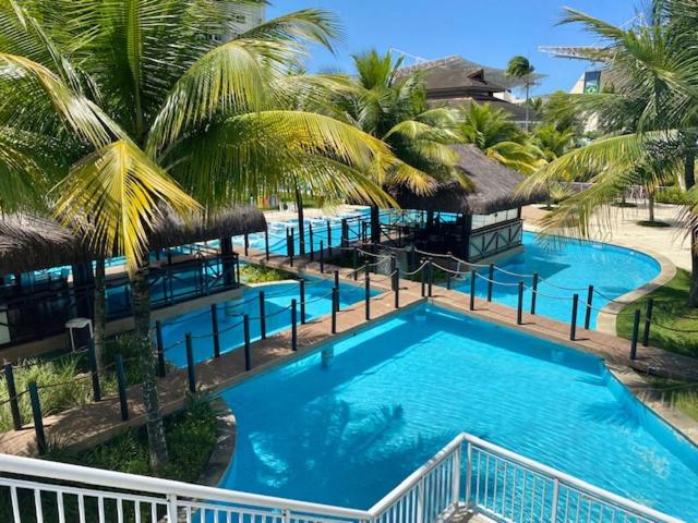 an overhead view of a large swimming pool with palm trees at Barra da Tijuca Depto decorado en Exclusivo Resort in Rio de Janeiro