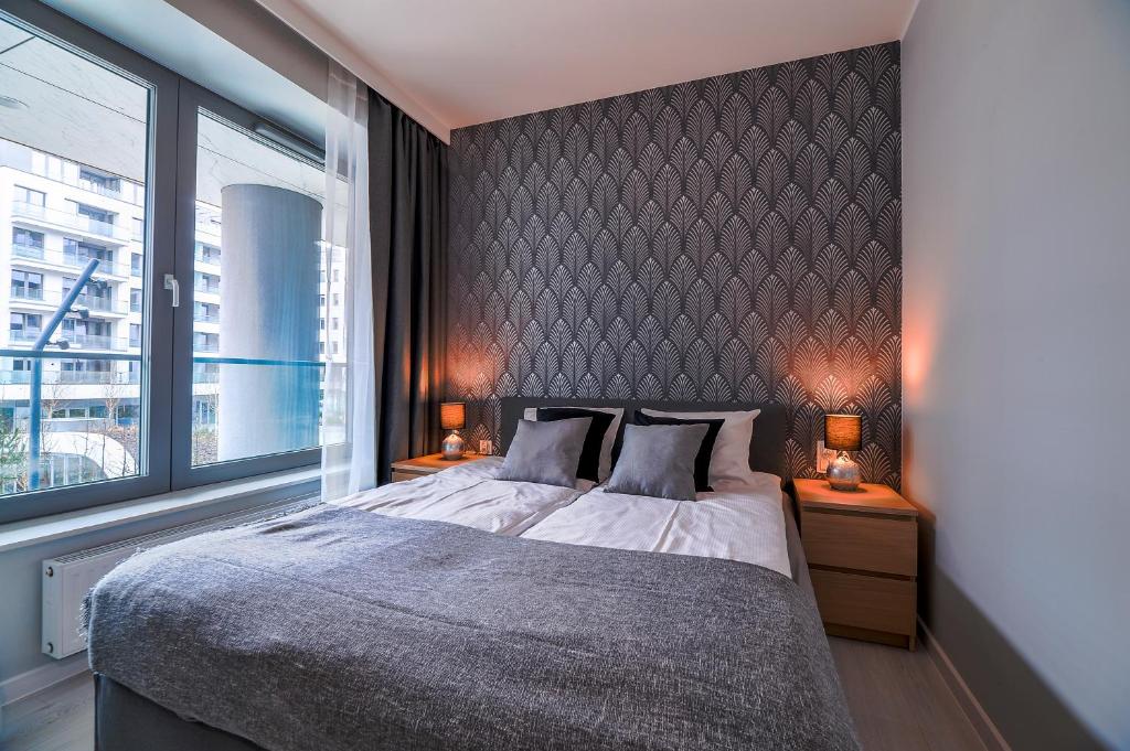 Posteľ alebo postele v izbe v ubytovaní CITYSTAY Plac Unii Gdynia Apartment