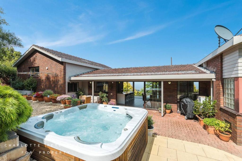 a hot tub in the backyard of a house at Hobart panoramic view with Spas in Hobart