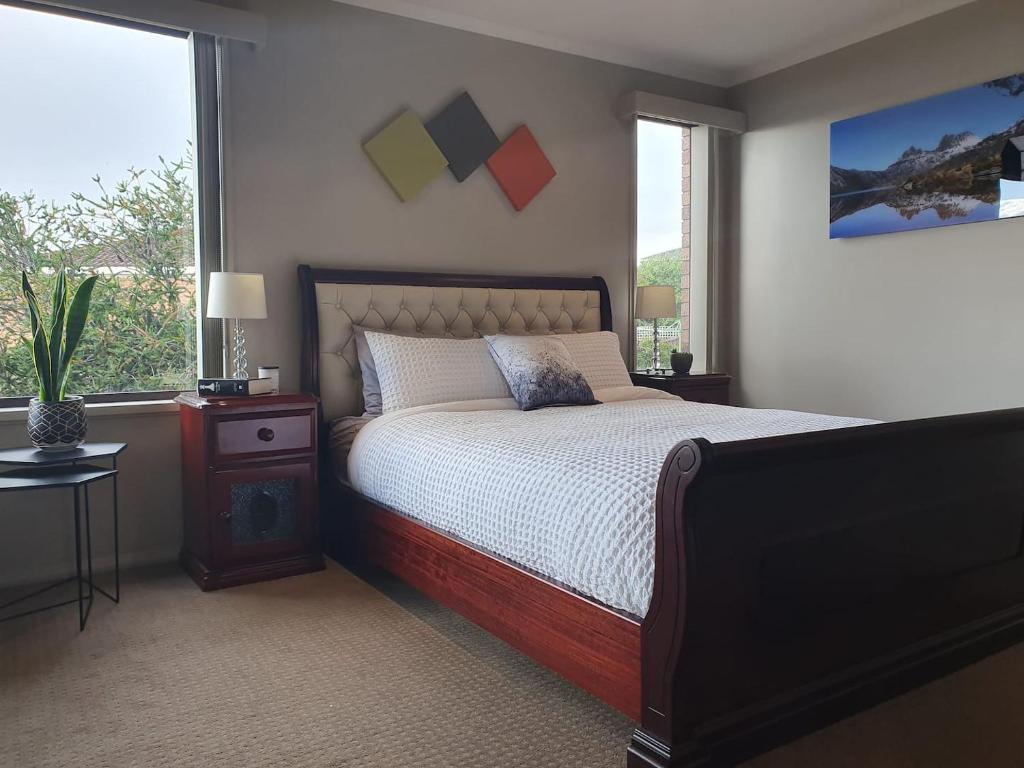 a bedroom with a large bed and a window at Hobart panoramic view with Spas in Hobart