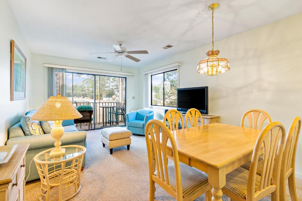 a dining room and living room with a table and chairs at Pinehurst Hideaway in Little River