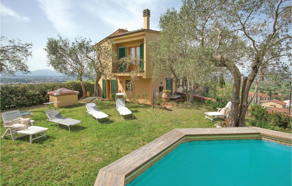 a villa with a swimming pool in front of a house at Casa Cigoli in San Romano