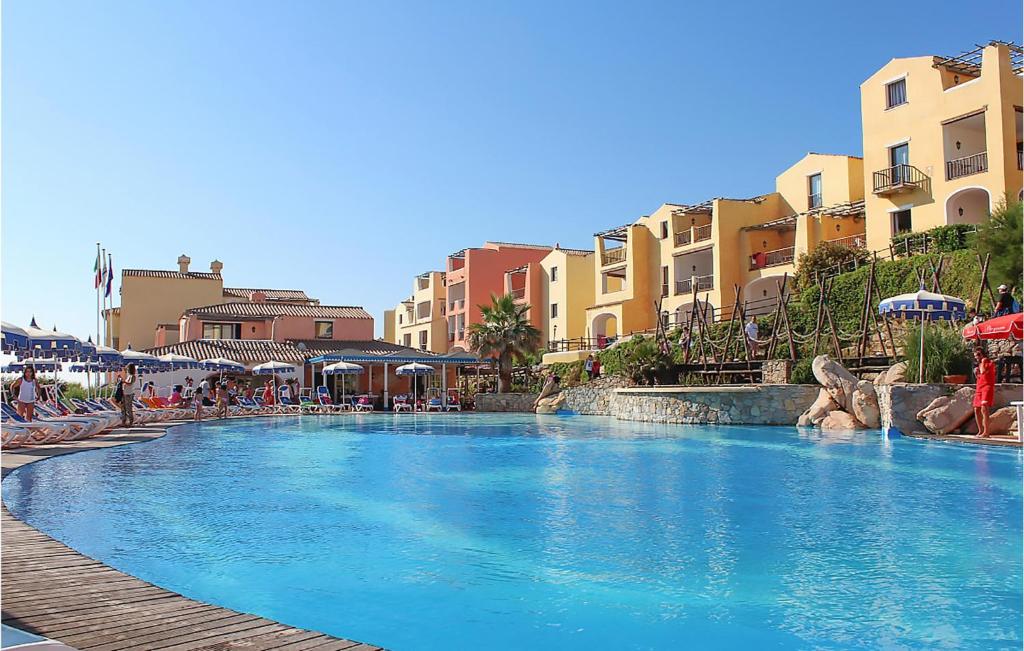 a large swimming pool in a resort with buildings at Bilo 4 in Cuile Pazzoni