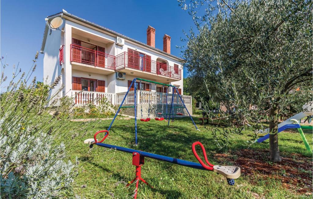 a house with a playground in front of it at 6 Bedroom Nice Home In Segotici in Šegotići