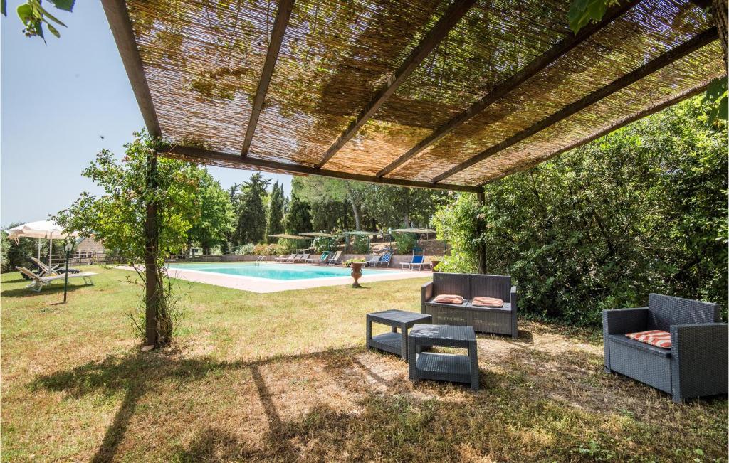 a patio with two chairs and a swimming pool at Materno 4 in Radicondoli