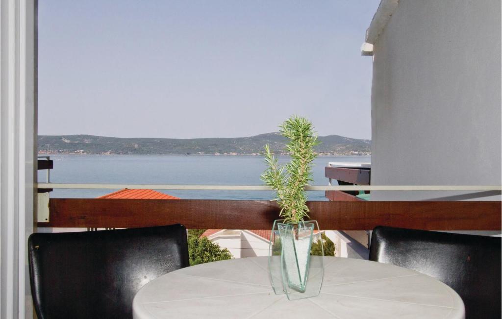 a vase on a table with a view of the water at Awesome Apartment In Sv, Petar With 2 Bedrooms And Wifi in Sveti Petar