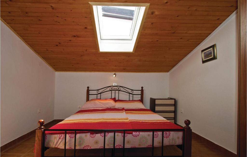 a bedroom with a bed with a skylight at Awesome Apartment In Sv, Petar With 2 Bedrooms And Wifi in Sveti Petar