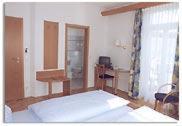 a living room with a bed and a window at Landgasthof zur Post in Heiligenberg