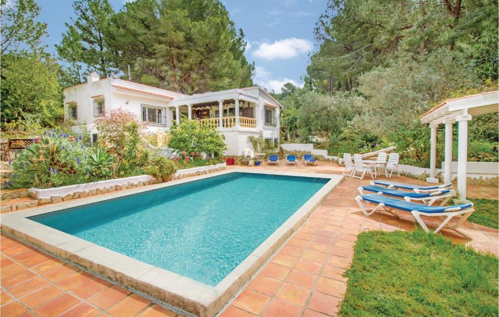 a swimming pool with chairs and a house at C, San Nicolas in Jesus Pobre