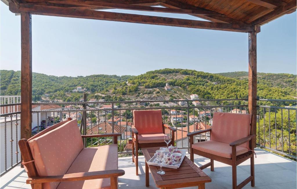 two chairs and a table on a balcony with a view at Awesome Home In Stomorska With 5 Bedrooms And Wifi in Stomorska