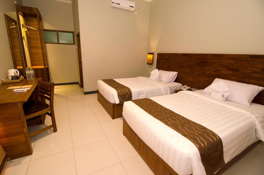 Letto o letti in una camera di Syailendra Hotel Syariah