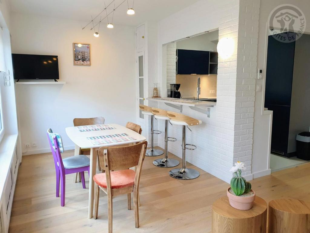 eine Küche und ein Wohnzimmer mit einem Tisch und Stühlen in der Unterkunft Maison à Malo les bains à 5mn de la plage in Dunkerque