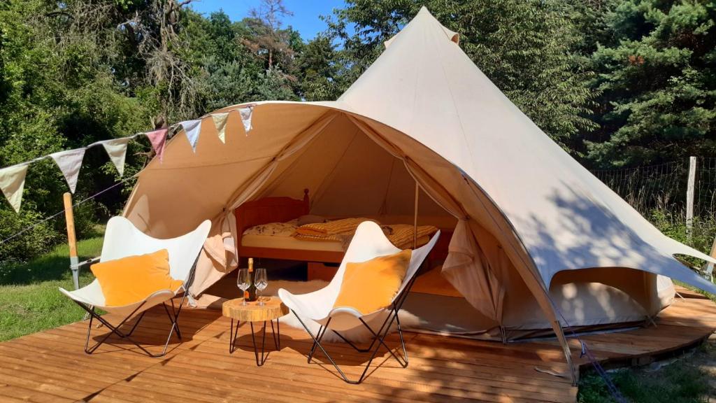 Tienda con sillas y cama. en Glamping v Sadu en Sadská