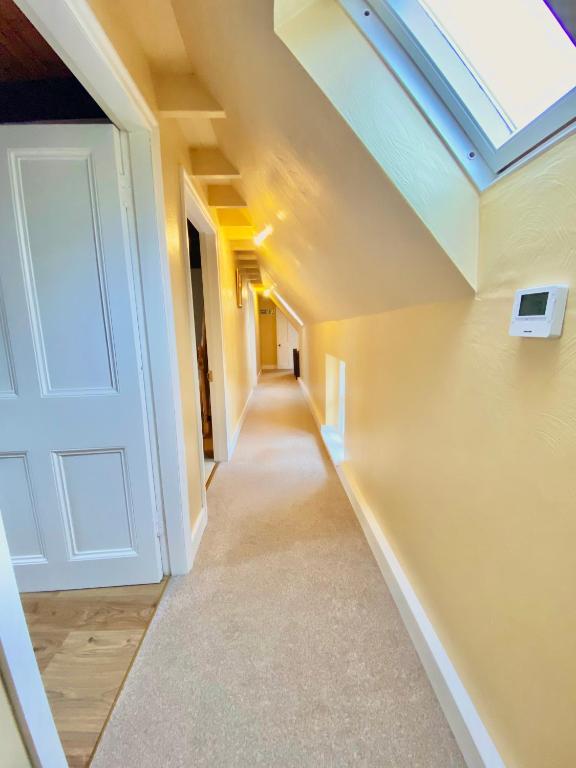 a hallway in a house with a skylight at The Old Vicarage in Berwick-Upon-Tweed