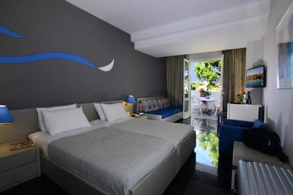 Postel nebo postele na pokoji v ubytování Mantenia Hotel