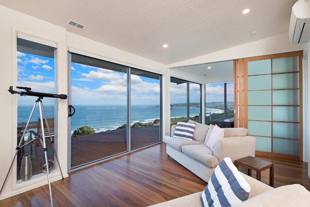 a living room with a view of the ocean at Seafarers Getaway in Apollo Bay