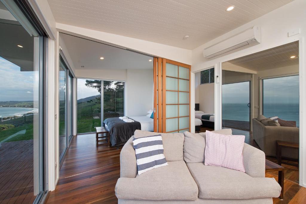 a living room with a couch and a bedroom at Seafarers Getaway in Apollo Bay