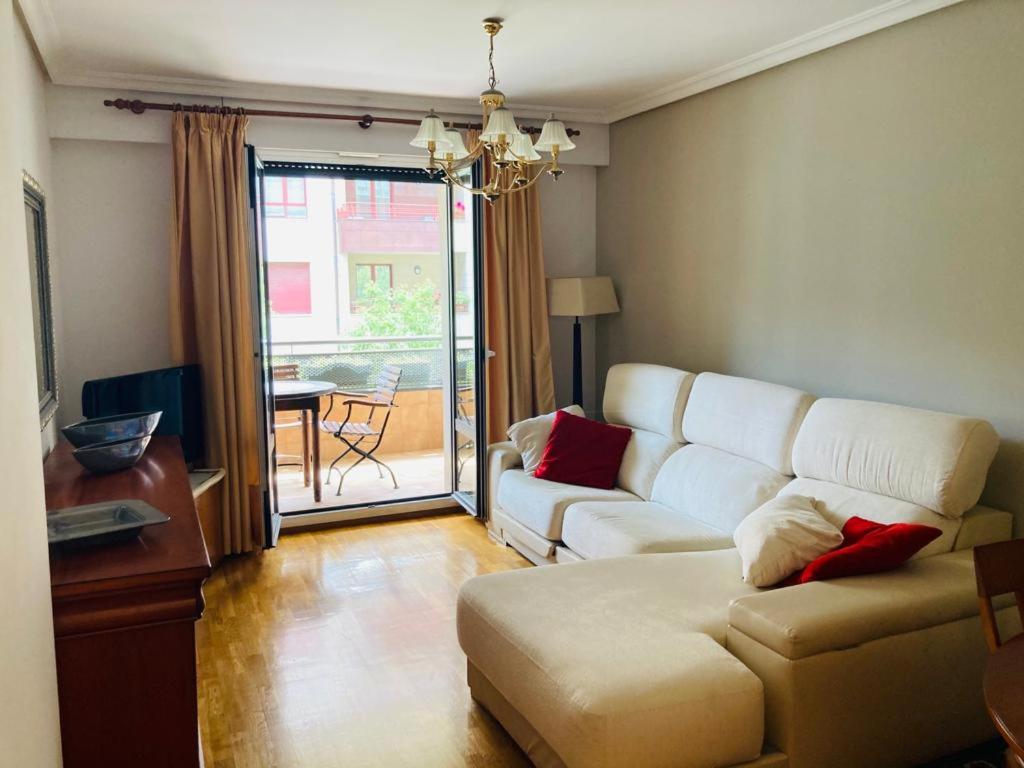 a living room with a white couch and a table at BentaBerri2 in Añorga-Lugariz