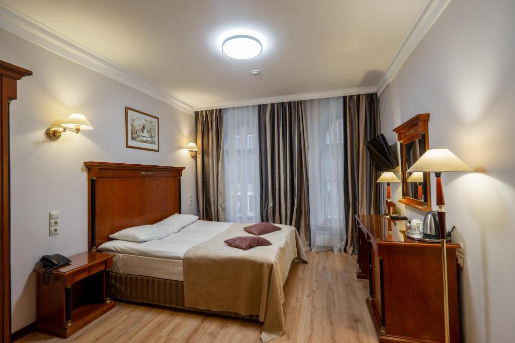 a hotel room with a bed and a window at Kristoff Hotel in Saint Petersburg