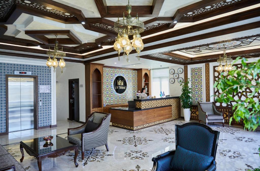 a lobby with chairs and a desk in a building at OLD TASHKENT Hotel & Spa in Tashkent