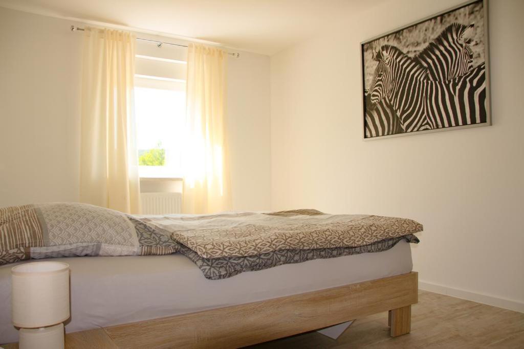 Postel nebo postele na pokoji v ubytování Gästehaus Mittendrin