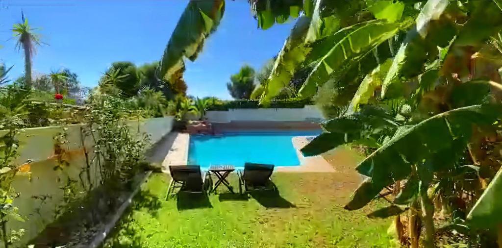 uma vista para a piscina a partir do jardim em VILLA Bed and Breakfast - kitchen, Pool, Barbecue and Large garden em Benidorm