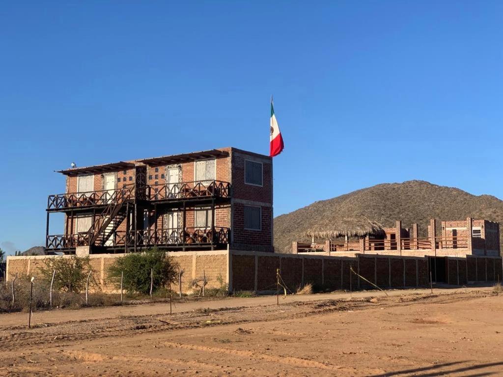 a building with a flag on top of it at Baja69 lodge in El Pescadero