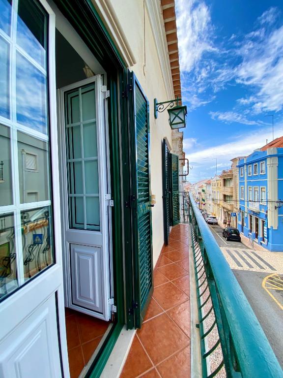 a building with a door on the side of a street at Casa Do Gerardo in Nazaré