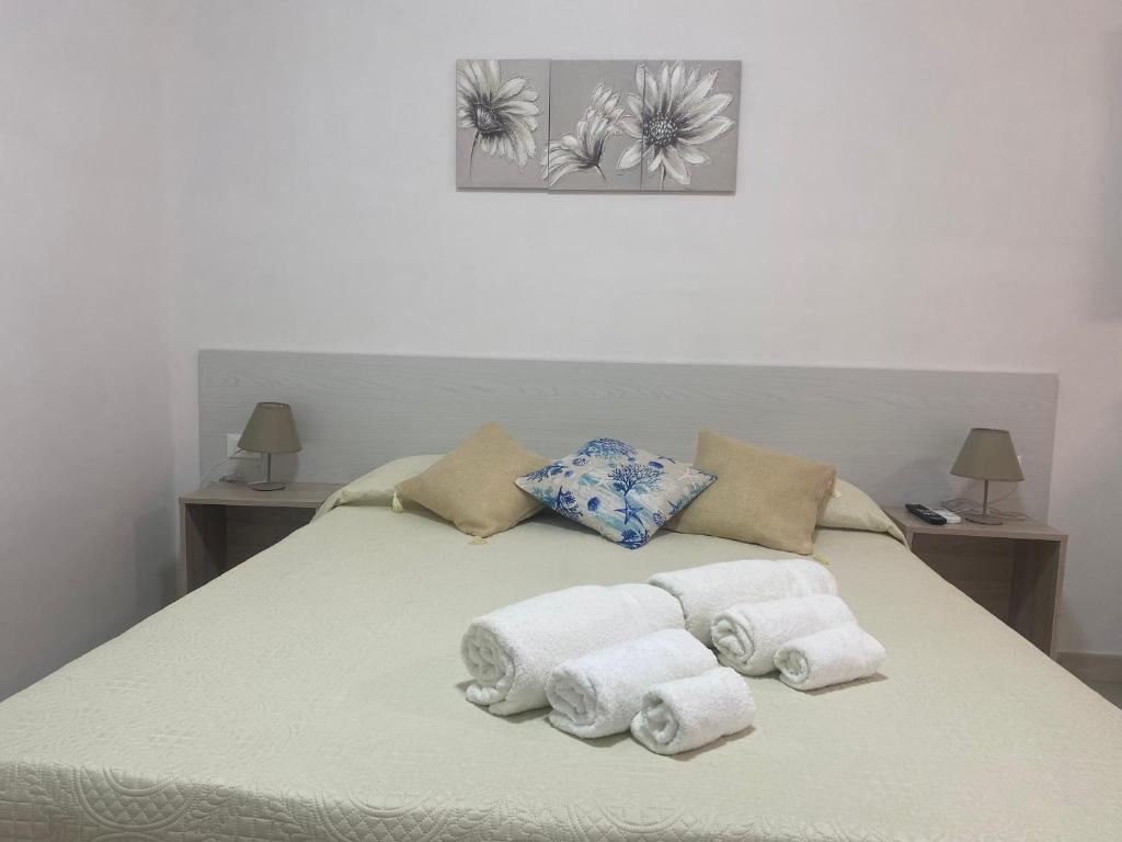 a bed with towels and pillows on it at Villa Misangi in Lampedusa