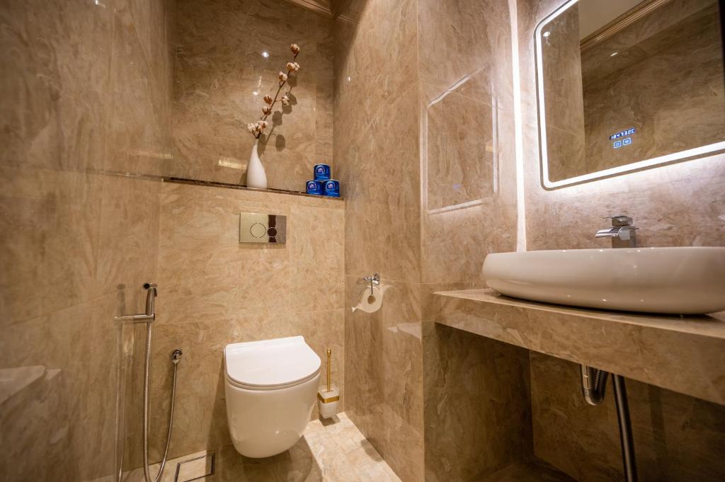 a bathroom with a white toilet and a sink at ACJ Residence @ Beside Cititel Hotel in Kota Kinabalu