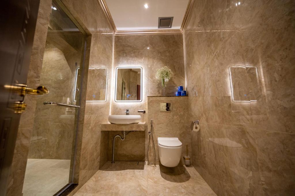 a bathroom with a shower and a toilet and a sink at ACJ Residence @ Beside Cititel Hotel in Kota Kinabalu