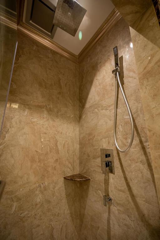 a bathroom with a shower with a shower head at ACJ Residence @ Beside Cititel Hotel in Kota Kinabalu