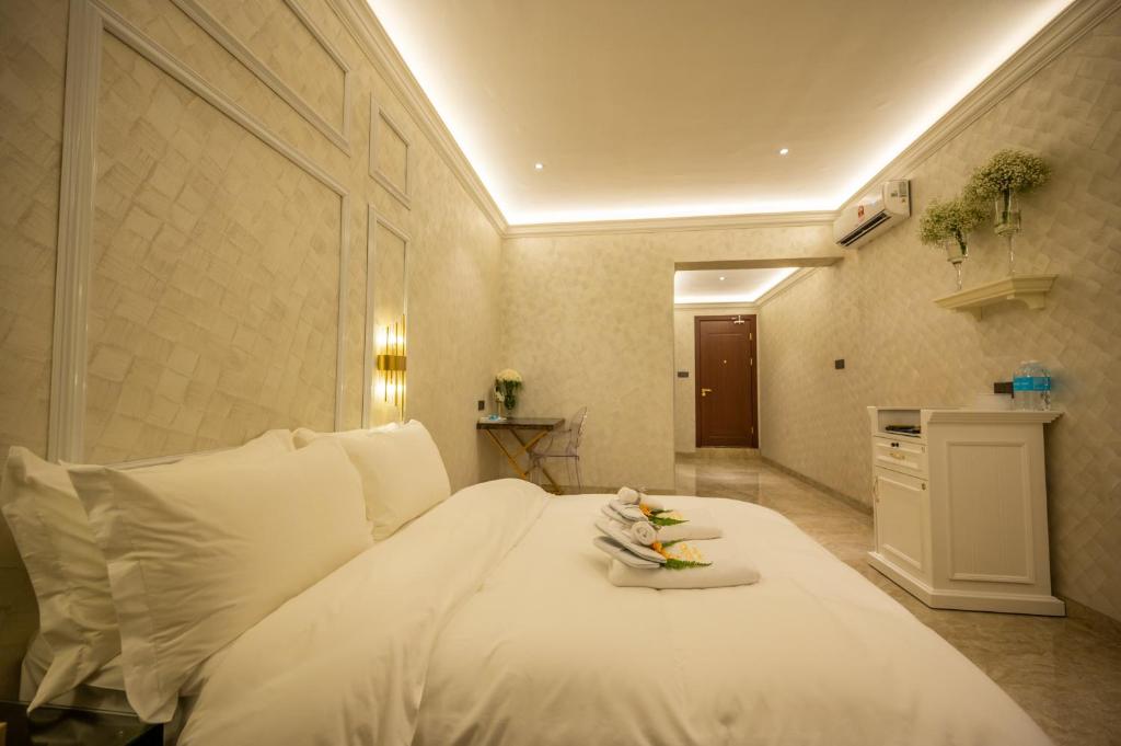 a bedroom with a white bed with white pillows at ACJ Residence @ Beside Cititel Hotel in Kota Kinabalu