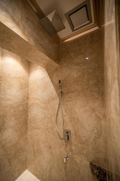 a bathroom with a shower with a hose in it at ACJ Residence @ Beside Cititel Hotel in Kota Kinabalu
