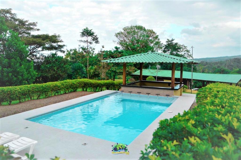 a swimming pool with a gazebo in a yard at Epic Adventure Lodge in San Miguel