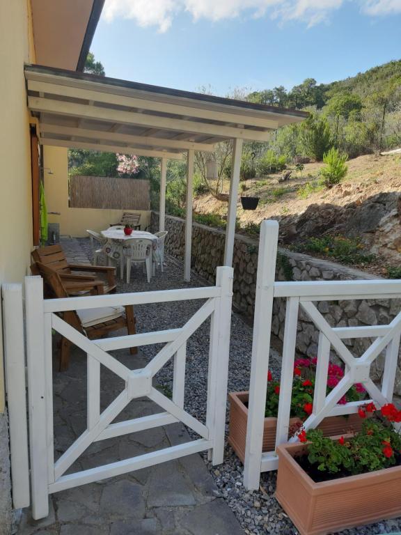 a patio with a white fence and a table at Casa Vacanza Paradise 2 in Marina di Campo