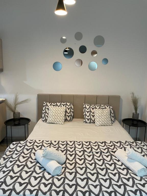 a bedroom with a large bed with two pillows on it at OTHER STORIES / Palas Retreat in Iaşi