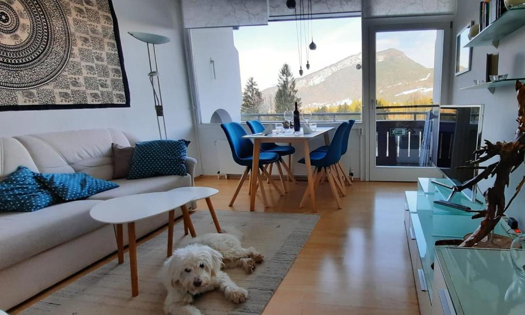 a living room with a dog laying on the floor at Lebensfreude Appartement in Bad Goisern