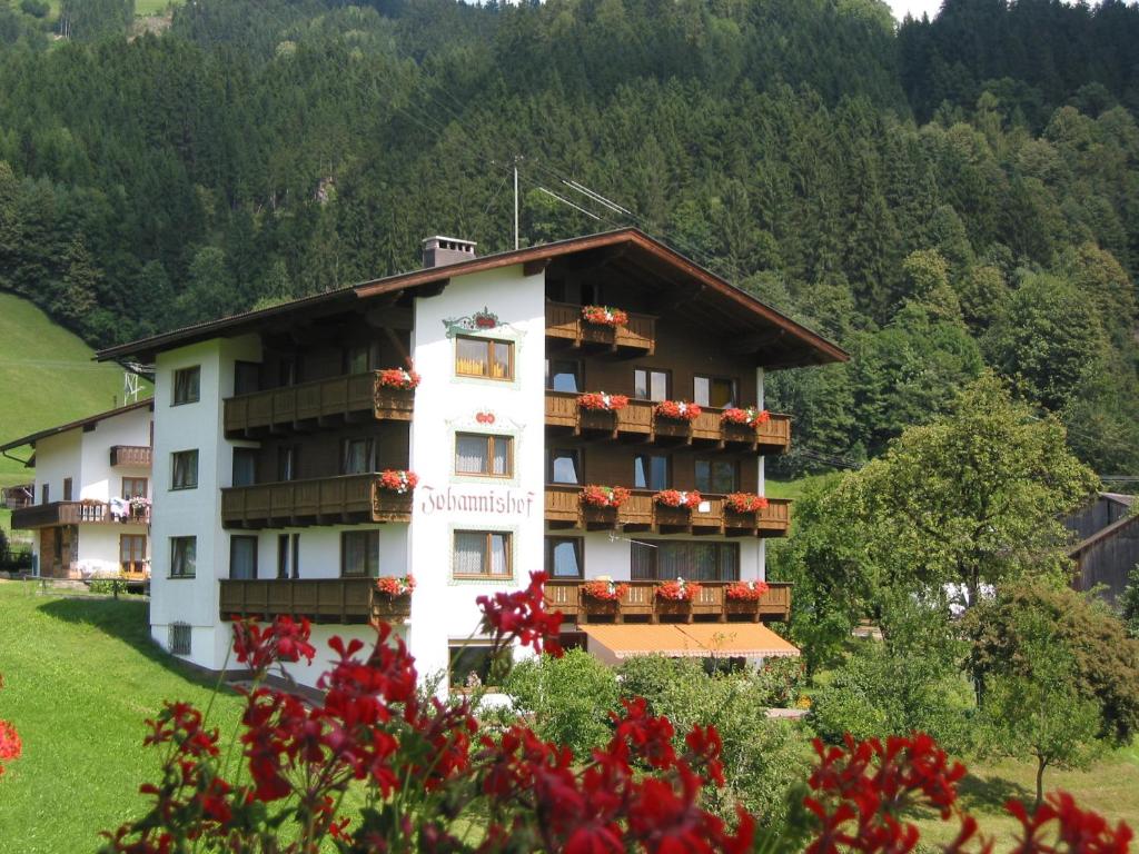 a large building with flower boxes on the windows at Johannishof in Stumm