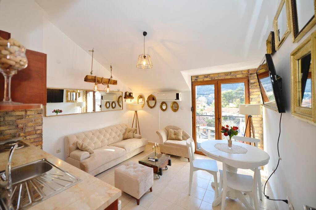 a living room with a couch and a table at Stylish apartment 22 in Kotor