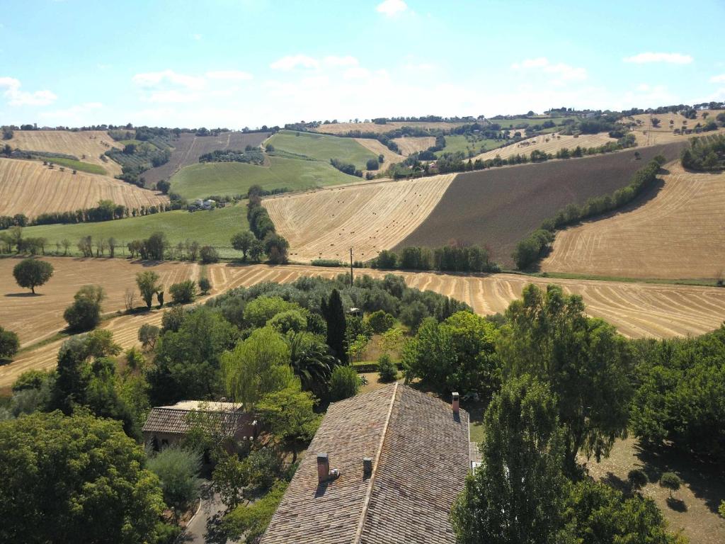 an aerial view of a farmhouse in the middle of a field at Il cipresso appartamento indipendente nella depandance in Ancona