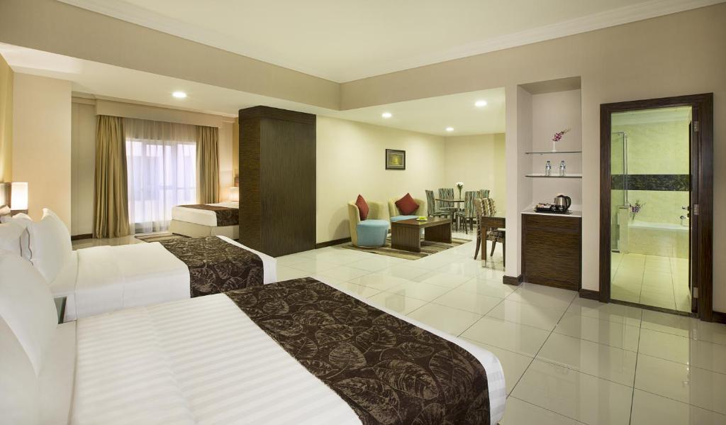 a hotel room with a bed and a bathroom at Gateway Hotel in Dubai