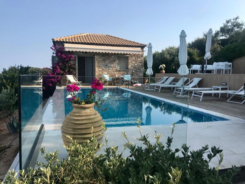 a villa with a swimming pool and a house at Luxury villa + guest house couchers de soleil mer in Skiathos Town