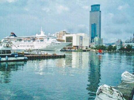 a cruise ship docked at a dock in a city at Rhine Inn in Keelung