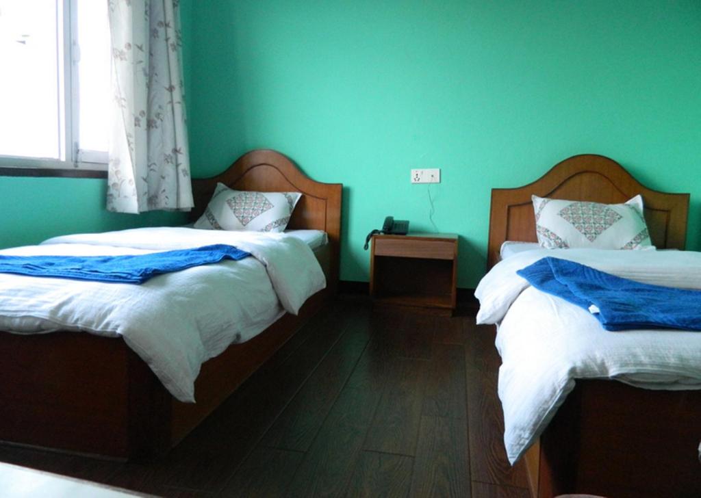 Postel nebo postele na pokoji v ubytování Mount Annapurna Guest House